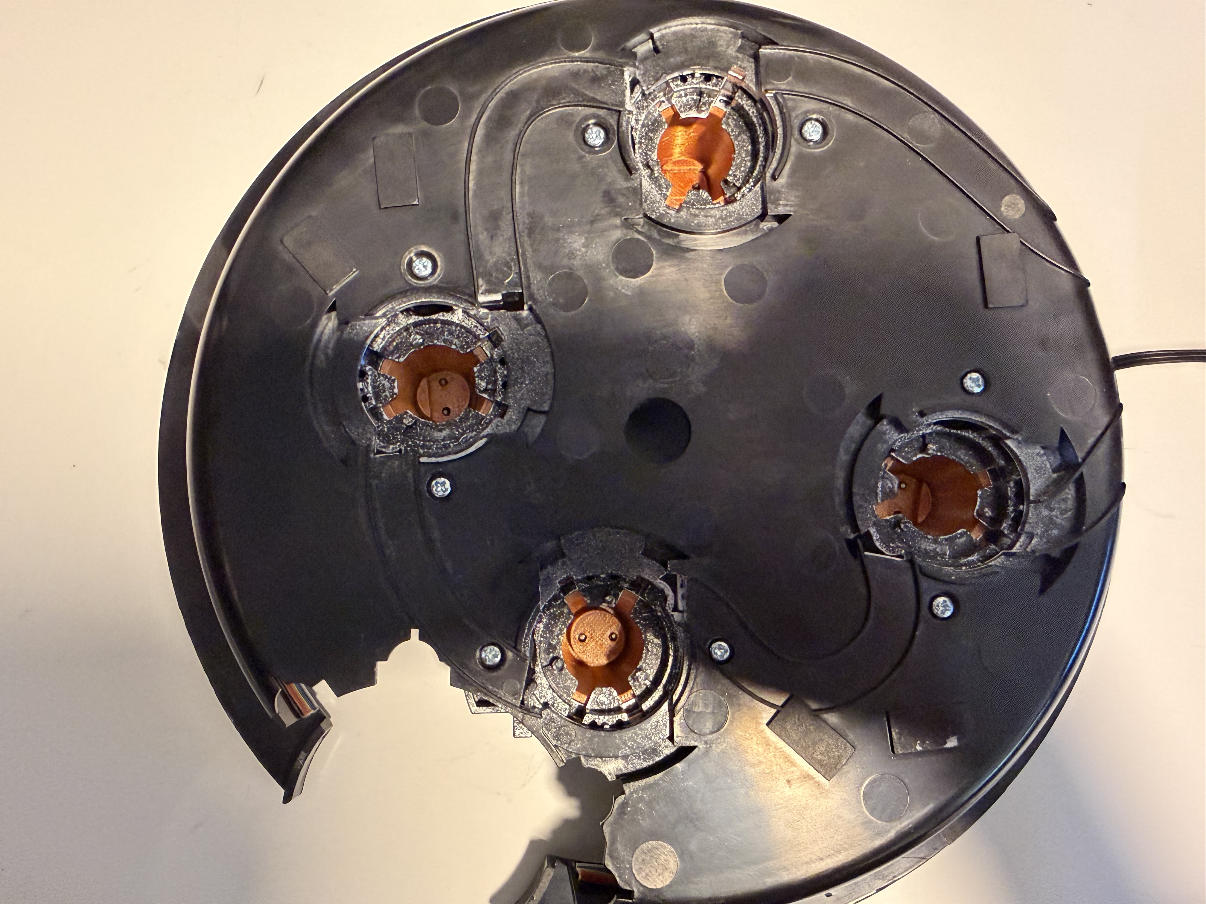 Cyclotron lid with the four original LED modules removed and the remaining black plastic peg mounts visible